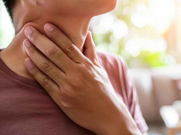 Man checking swollen lymph nodes as a possible STD symptom.
